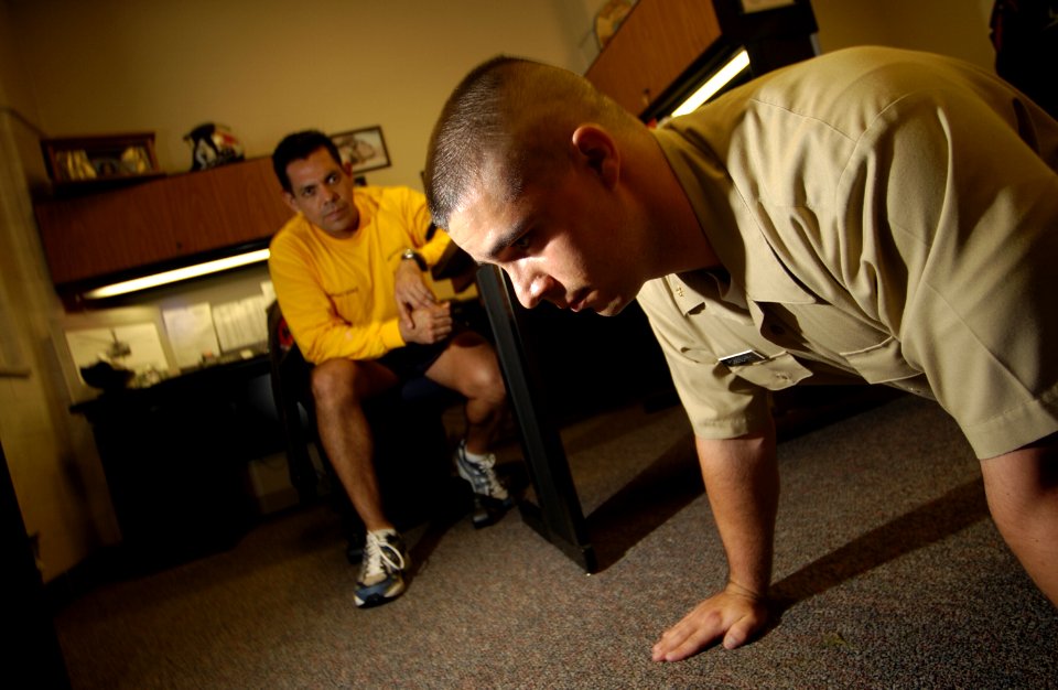 US Navy 031112-N-5862D-006 At Officer Candidate School (OCS) onboard NAS Pensacola, Chief Aviation Machinist Mate Jorge Ouiroz gives Officer Candidate Jason Roseberry some time to think in the lean and rest position