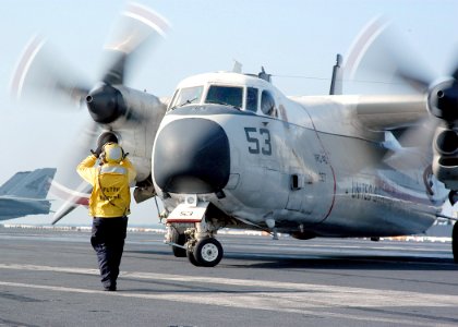 US Navy 031118-N-6278K-003 Aviation Boatswain's Mate 3rd Class Jesse Borja directs a C-2A Greyhound