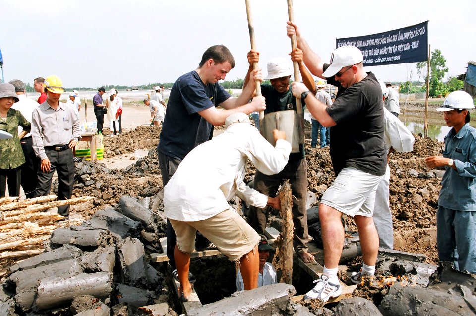 US Navy 031120-C-0000T-001 Sailors assigned to USS Vandegrift (FFG 48) assist local workers in digging a foundation for a new school building at Doi Lau Hamlet Kindergarten