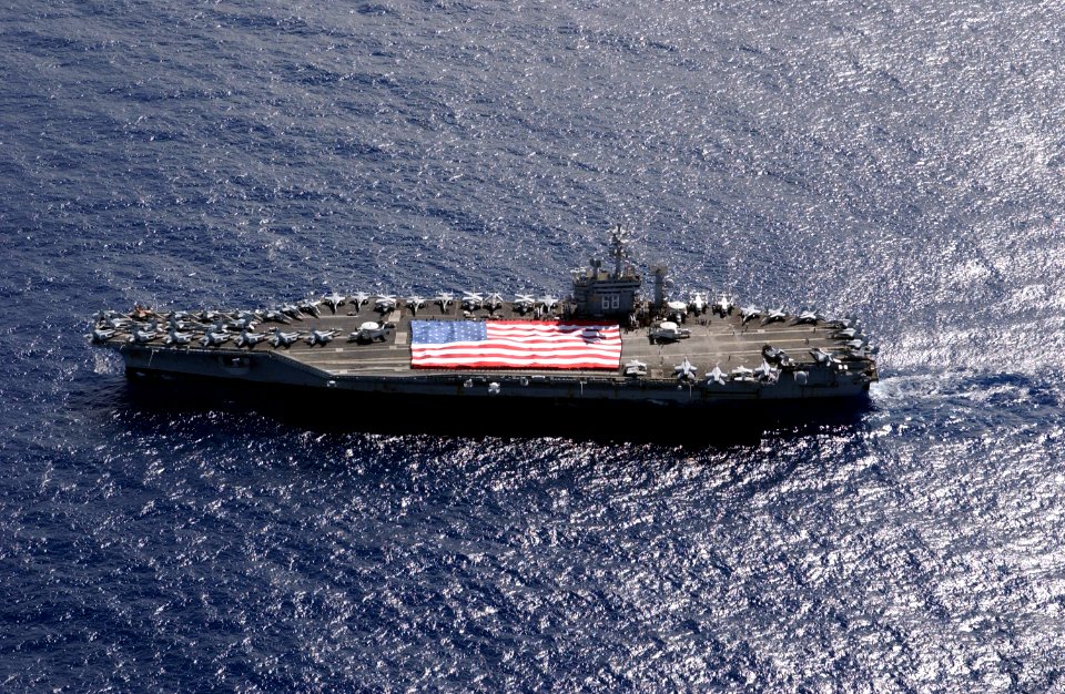 US Navy 031103-N-6536T-004 USS Nimitz (CVN 68) crewmembers participate in a flag unfurling rehearsal with the help of family and friends