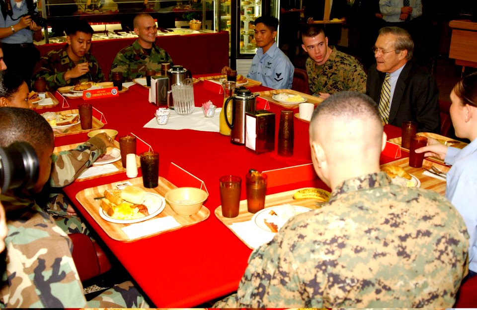 US Navy 031116-N-9712C-002 U.S. Secretary of Defense Donald H. Rumsfeld, talks with Marine, Air Force, Army, and Navy personnel based in Okinawa, Japan, during a Sunday brunch