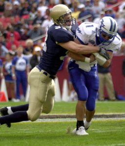 US Navy 031004-N-9693M-735 Air Force quarterback Chance Harridge is sacked by Navy's safety Josh Smith