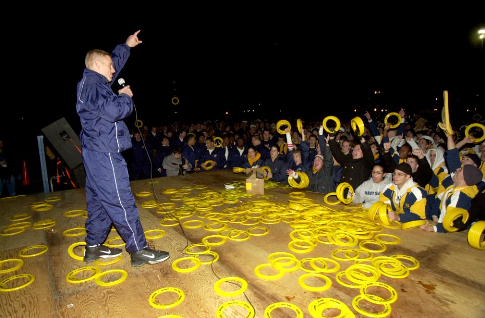 US Navy 031204-N-9693M-001 Navy football team Quarterback Craig Candeto leads the Brigade of Midshipmen in a cheer during a Go Navy, Beat Army pep rally