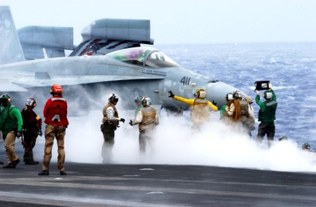 US Navy 031125-N-5821P-004 Flight deck personnel prepare for the launch of an F-A-18 Hornet from one of four steam powered catapults