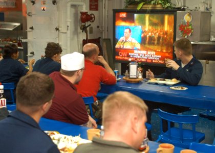 US Navy 031214-N-0715P-021 Sailors aboard the USS Peleliu (LHA 5) watch in interest during a live broadcast announcing the capture of former Iraqi Dictator, Saddam Hussein, on the ship's mess decks