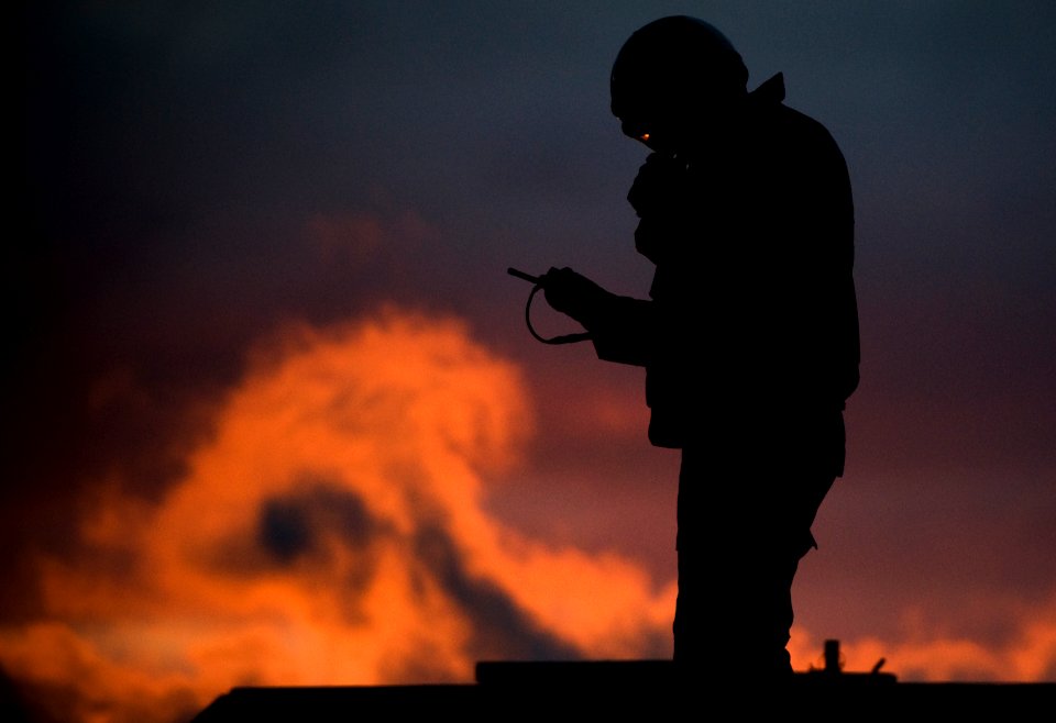 US Navy 101215-N-2055M-282 An aircraft director prepares to launch aircraft from the aircraft carrier USS Carl Vinson (CVN 70) at sundown
