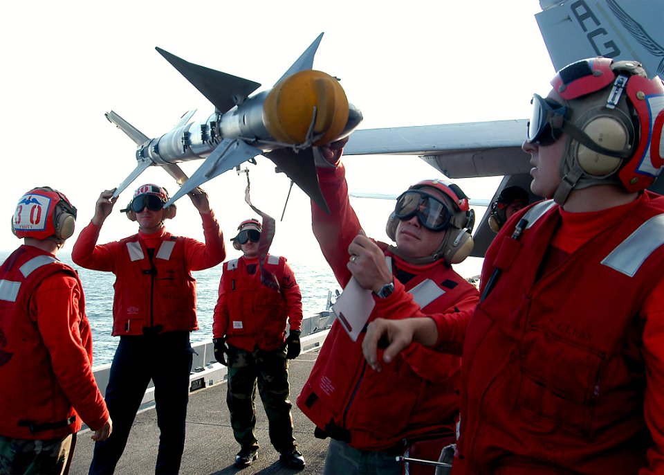 US Navy 031112-N-3986D-001 Aviation ordnancemen inspect an air-to-air missile