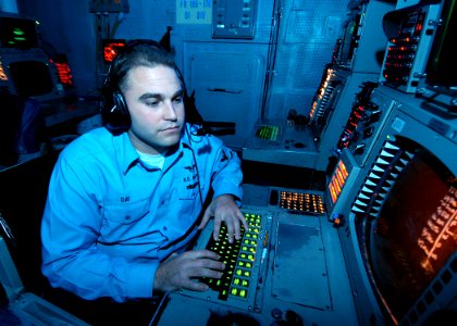 US Navy 031128-N-6278K-001 Operations Specialist 3rd Class Joe Day, from Riverside, Calif., manages a Tactical Data Link (TDL) among the ships and aircraft assigned to USS George Washington (CVN 73) Carrier Strike Group (CSG)