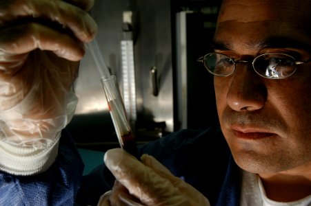 US Navy 031206-N-6278K-001 Hospital Corpsman 2nd Class Carlos Aguilar, of Baja, Calif., conducts lab tests in the medical clinic aboard USS George Washington