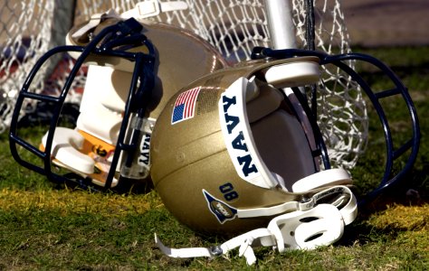 US Navy 031230-N-9693M-001 A pair of Navy helmets lays on the field prior to the EV1.Net Houston Bowl at Reliant Stadium in Houston, Texas photo