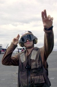 US Navy 031013-N-2143T-004 Aviation Electronics Technician 3rd Class Adam Berdard performs start-up checks