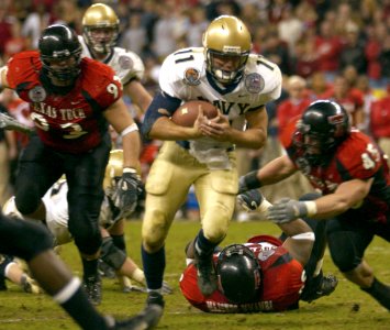 US Navy 031230-N-9693M-019 Navy quarterback Craig Candeto gains yardage on a rushing attempt during the EV1.Net Houston Bowl at Reliant Stadium in Houston, Texas