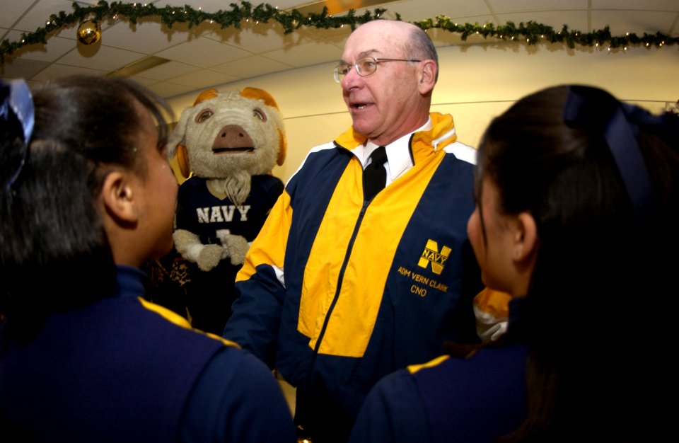 US Navy 031204-N-9693M-046 The Chief of Naval Operations (CNO) Adm. Vern Clark visits with U.S. Naval Academy Midshipmen cheerleaders and band members as they pass through the halls of the Pentagon during a Go Navy, Beat Army