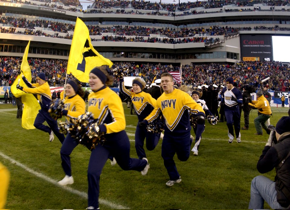 US Navy 031206-N-9693M-032 Navy Cheerleaders take to the field ahead of the navy Midshipman at the start of the 104th Army Navy Game