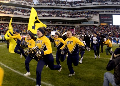US Navy 031206-N-9693M-032 Navy Cheerleaders take to the field ahead of the navy Midshipman at the start of the 104th Army Navy Game photo
