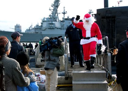 US Navy 031219-N-2903K-001 Santa Claus comes across the brow from the nuclear powered Los Angeles class attack submarine USS Jacksonville (SSN 699) after the submarine returned home to Naval Station Norfolk from a three-month d
