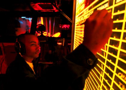 US Navy 040104-N-7408M-004 Airman Recruit Milton H. Saul of New York, N.Y., keeps track of on-going flight operations on a light board in the Primary Flight Control (PRI-FLY)