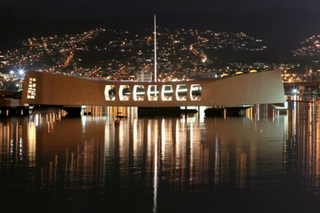 US Navy 031206-N-3228G-001 The USS Arizona Memorial is bathed in light from a neighboring community the night before the 62nd Commemoration of the Dec. 7, 1941 attack