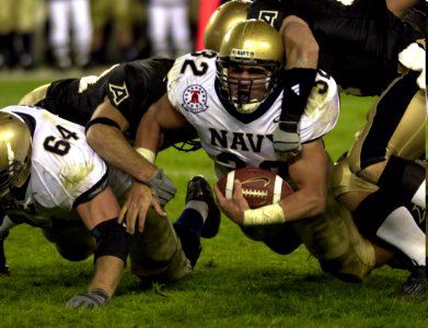 US Navy 031206-N-9693M-501 Kyle Eckel is tackled after a substantial gain during the 104th playing of the Army Navy game