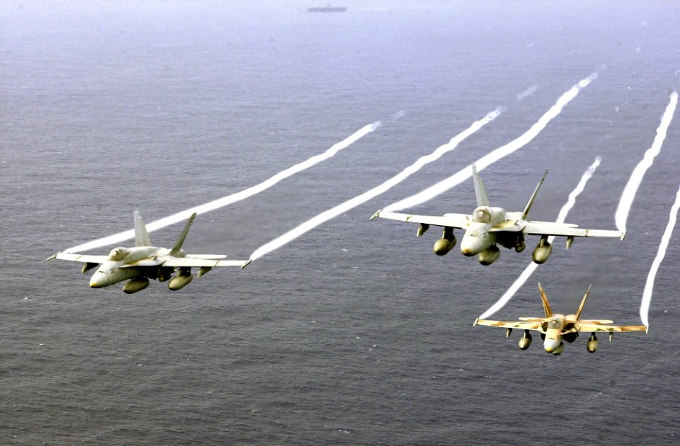 US Navy 031026-N-6536T-005 F-A-18A Hornets fly over the Western Pacific Ocean during flight operations