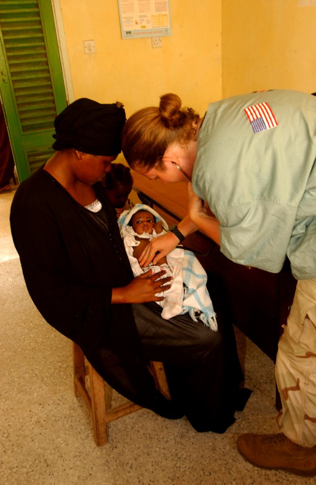 US Navy 040114-N-3236B-017 Hospital Corpsman 2nd Class Laura Bicking examines a young Kenyan infant during Edged Mallet-04