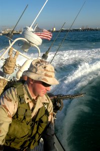 US Navy 031208-N-2669M-012 Turning port, Coast Guard Boatswain's Mate 3rd Class Shannon Brewer assigned to Naval Coastal Warfare Group One (NCWG 1) skillfully maneuvers a Coast Guard inshore patrol boat