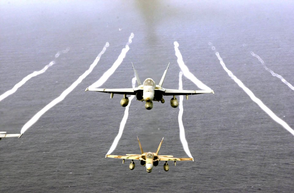 US Navy 031026-N-6536T-002 F-A-18A Hornets ly over the Western Pacific Ocean during flight operations