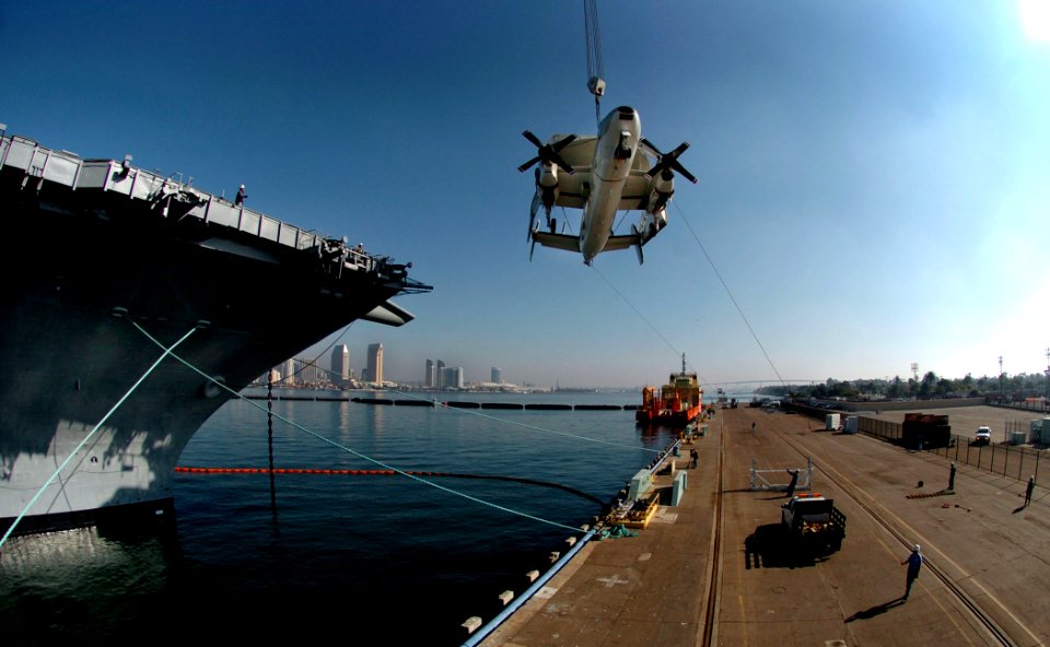 US Navy 040108-N-6213R-078 A retired E-2 Hawkeye is hoisted aboard the decomissioned aircraft carrier Midway at Naval Air Station North Island, Calif