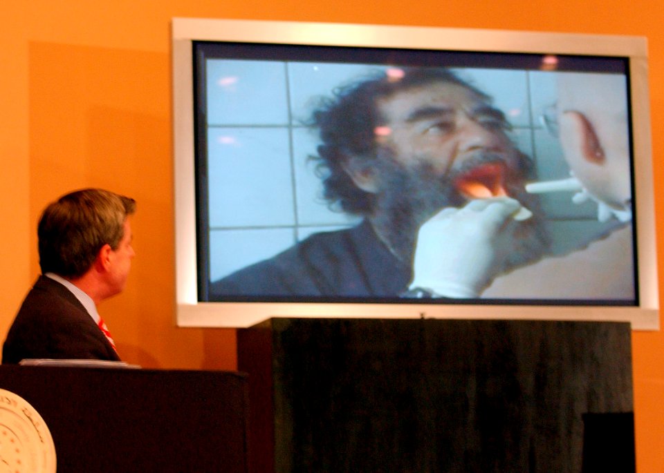 US Navy 031214-F-1093P-003 Ambassador L. Paul Bremer, Coalition Provisional Authority Administrator, presents a video of Saddam Hussein going through a medical examination
