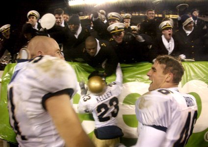 US Navy 031206-N-9693M-502 Navy linebacker Bobby McClarin, left, congratulates fullback Ryan Barry, right, as defensive back Vaugn Kelly shares a celebratory moment with Midshipmen following the 104th Army Navy Game