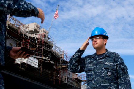 US Navy 101123-N-9643K-216 Logistics Specialist Seaman Ryan Neal grants permission for a Sailor to board the messing and berthing barge for the amp