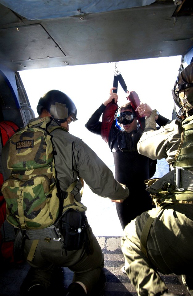 US Navy 031213-N-5319A-013 Gunners Mate 1st Class Casey Rodgers assigned to Explosive Ordnance Disposal Mobile Unit Six (EODMU 6) is hoisted up into a SH-60 Seahawk