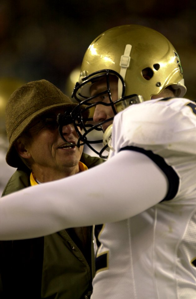 US Navy 031206-N-9693M-521 Secretary of the Navy, the Honorable Gordon R. England congratulates Navy nose guard Eric Frey on his teams winning the 104th Army Navy Game