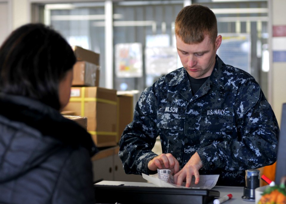 US Navy 101116-N-2013O-036 Logistics Specialist Seaman Jason Wilson, from Eden, N.C., assists a customer in the Fleet Industrial Supply Center Yok