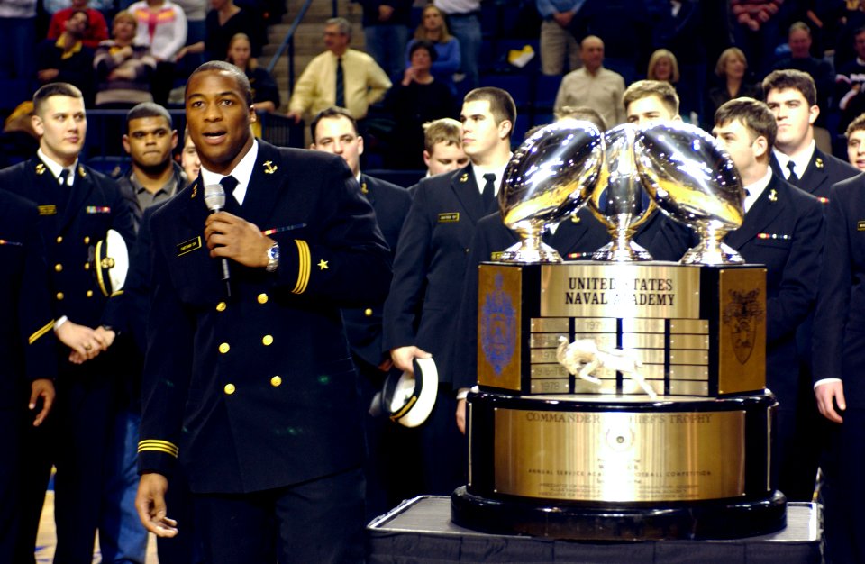 US Navy 040130-N-9693M-014 U.S. Naval Academy football team co-captain Eddie Carthan addresses the crowd next to the Commander-in-Chief's trophy