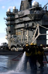 US Navy 031218-N-5319A-013 Sailors participate in a Scrub Ex on the flight deck