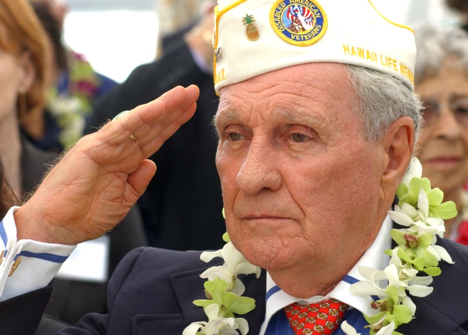 US Navy 031207-N-7391W-052 Authur Forcier, Hawaii's State Commander of the Disabled American Veterans, salutes the national ensign during the 62nd anniversary of the attack on Pearl Harbor