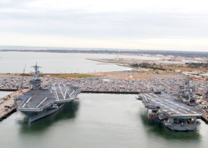 US Navy 101130-N-9589S-155 USS George H. W. Bush (CVN 77), left, and USS Enterprise (CVN 65) are docked at Naval Station Norfolk photo