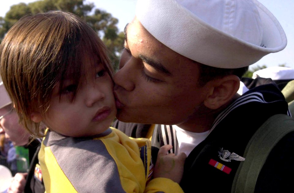 US Navy 031105-N-2143T-001 A Nimitz sailor greets his family after arriving home aboard USS Nimitz (CVN 68)