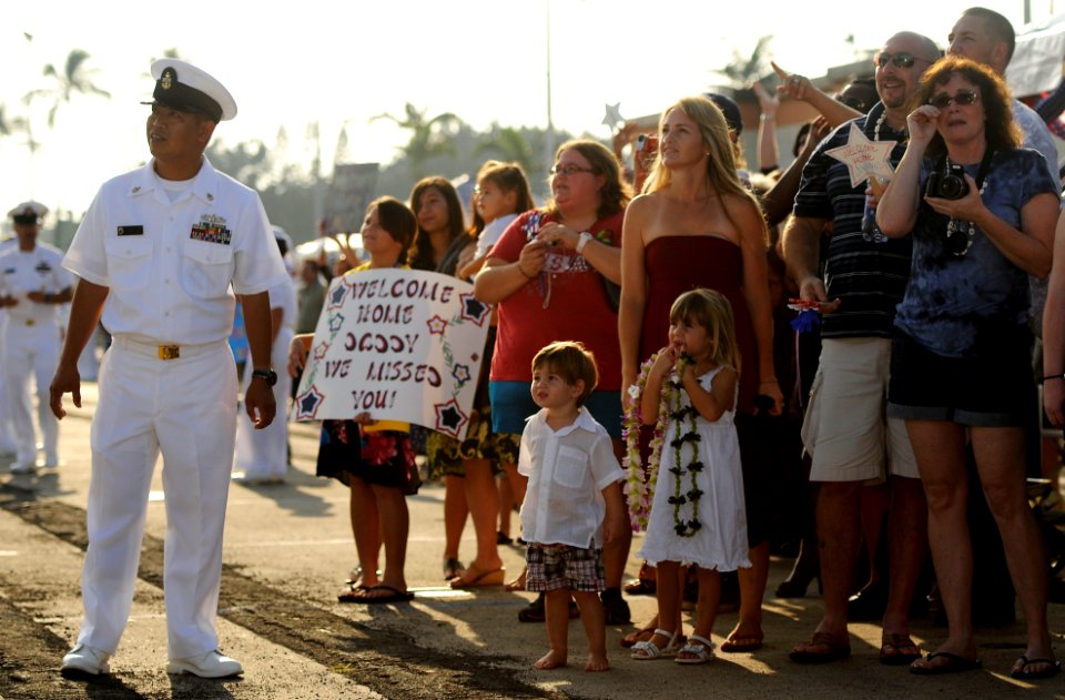 US Navy 101214-N-7498L-088 Senior Chief Culinary Specialist Benjamin Alejo stands by as friends and family members wait for the guided-missile fri
