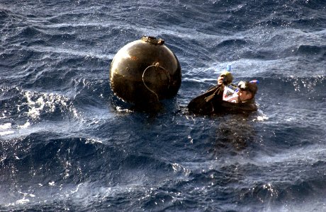 US Navy 031213-N-5319A-009 Gunners Mate 1st Class Casey Rodgers assigned to Explosive Ordnance Disposal Mobile Unit Six (EODMU 6) attaches 20 pounds of explosives to a Dummy Mine during a mine counter measures exercise photo