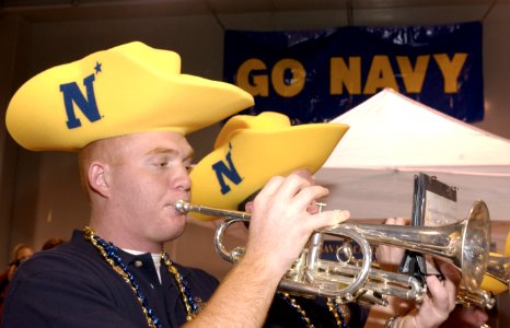 US Navy 031229-N-9693M-002 U.S. Naval Academy (U.S.N.A.) Midshipmen 4th Class Jason Pallota, from Daytona, Fla., plays the trumpet during the EV1.Net Rodeo Pep Rally in Reliant Arena