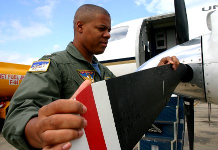 US Navy 031113-N-5821W-001 Lt. Johnny Williams, a member of NAS Sigonella's Mediterranean Express (MEDEX), checks the propeller