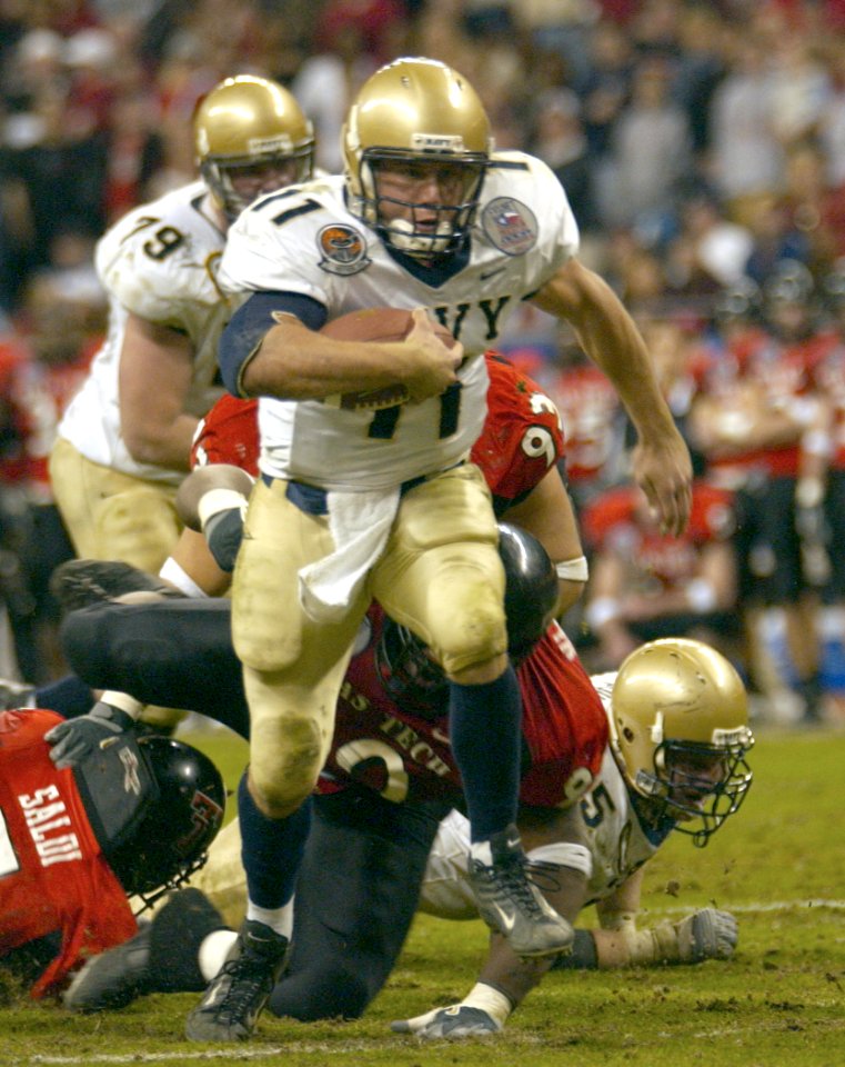 US Navy 031230-N-9693M-018 Navy quarterback Craig Candeto gains yardage on a rushing attempt during the EV1.Net Houston Bowl at Reliant Stadium in Houston, Texas
