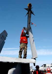 US Navy 040217-N-3986D-034 Aviation Ordnanceman Airman Gary Alford of Paris, Texas, checks an inert AIM-9 Sidewinder missile, used for training and is identified by its blue color