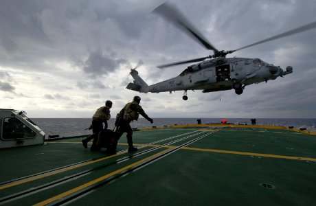 US Navy 040212-N-5319A-007 Members assigned to Explosive Ordnance Disposal Mobile Unit Six (EODMU 6) carry their fast rope back to an HH-60H Seahawk helicopter photo