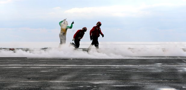 US Navy 110131-N-3374C-063 Sailors run across the flight deck of the aircraft carrier USS George H.W. Bush (CVN 77) during flight operations