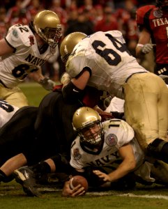 US Navy 031230-N-9693M-014 Navy quarterback Craig Candeto scoots under the pile to score the first of two Navy touchdowns in the EV1.Net Houston Bowl at Reliant Stadium in Houston, Texas