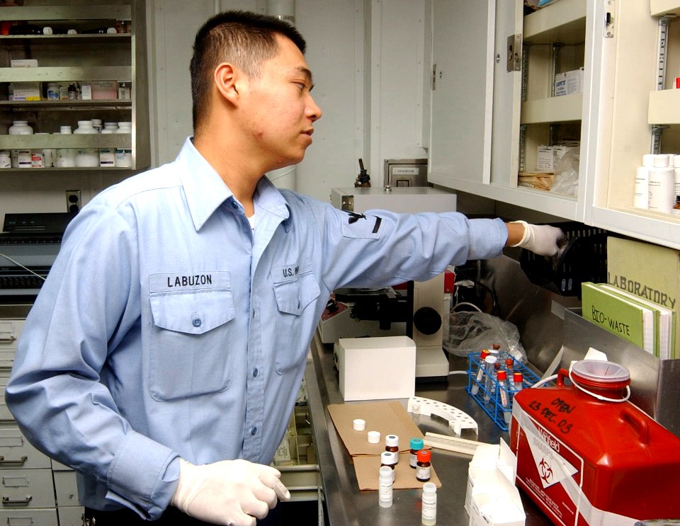 US Navy 040116-N-0000W-113 Hospital Corpsman 3rd Class Salvador Labuzon works in a medical department space