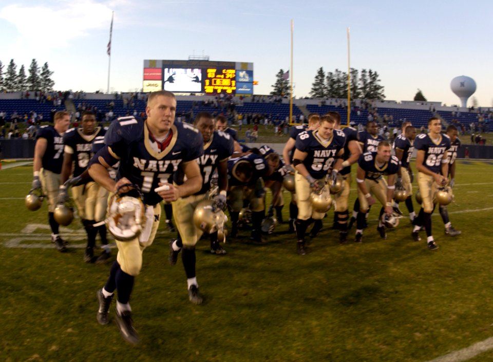 US Navy 031122-N-9693M-008 Led by Navy quarterback Craig Candeto 22 seniors leave the gridiron at Jack Stevens field for the final time following the Midshipmen's win over the Chippewas 63-34 in Annapolis, Md